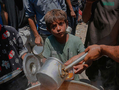 Humanitarian aid reaches displaced civilians in Deir al-Balah, where residents gather for food assistance amid the challenging conditions of life in Gaza