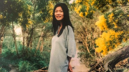 A young Kim Chi Pho in a garden in the middle of autumn