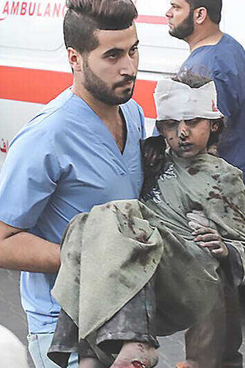 Medics rush injured Palestinian child to Al-Shifa Hospital in Gaza City post Israeli airstrike on October 11, 2023