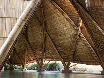 Sweeping bamboo arches soar across the roof of The Arc at Green School in Bali, Indonesia, merging organic beauty with cutting-edge engineering