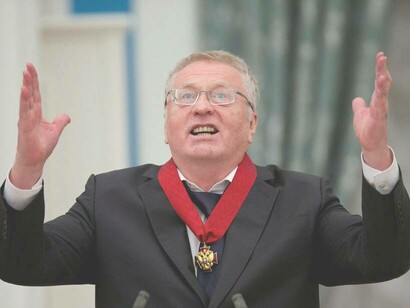 Vladimir Zhirinovsky raising his hands to the sky during his  medal-awarding ceremony in Moscow, Russia 