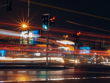 Long-exposure city traffic going through signals, representing the rapidly growing pace of technological competition