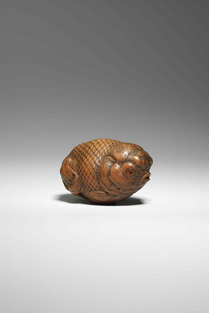 Netsuke. Goldfish. Made of wood with inlaid eyes of amber. Made by Masanao I of Ise. Japan, , late 1700s © The Trustees of the British Museum