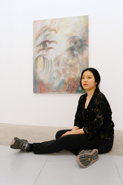 Naeun Kang captured in front of her work With your 
face this close (2), 2024. Courtesy of Nevven Gallery. Photography by Sara Lorusso
