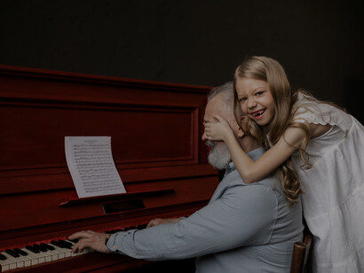 A bond between grandfather and granddaughter is special, as they play together on the piano