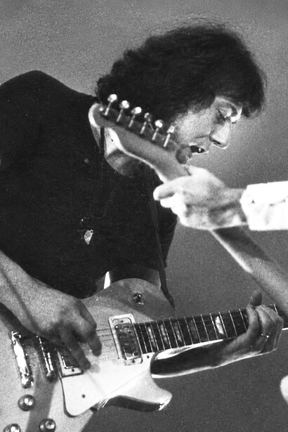 A vintage photograph of Marcello Capra during a live performance in the early years of his musical journey