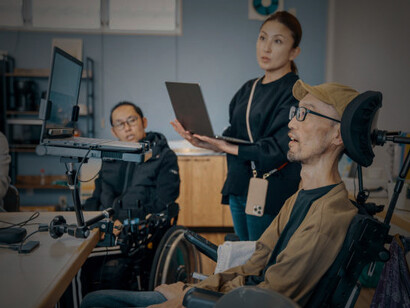 Individuals with different abilities collaborating in a small office setting