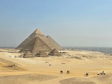 The pyramids of Giza rising above the vast Egyptian desert, representing the monumental scale of the Egypt sequence in Transformers: Revenge of the Fallen