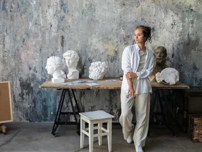 An artist in an art studio, a sculptor working in a studio filled with natural light