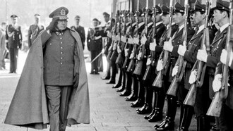 Augusto Pinochet reviews troops inside the presidential palace in Santiago, Chile in 19