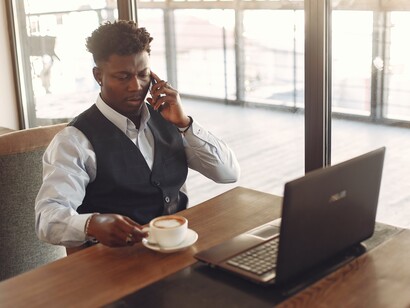 A man on the phone discussing his business plan to a potential partner