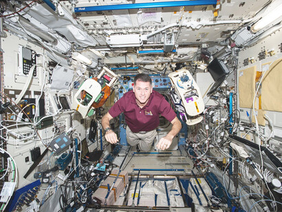 NASA astronaut Shane Kimbrough is seen conducting the Spheres-Halo experiment aboard the International Space Station. The experiment uses two small, self-contained satellites (SPHERES), equipped with ring-shaped structures, to test wireless power transfer and formation flight using electromagnetic fields