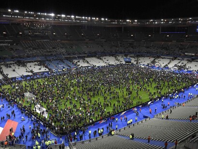 Spectators gather on the pitch at the Stade de France after explosions were heard outside the national stadium. Photograph: Franck Fife/AFP/Getty Images