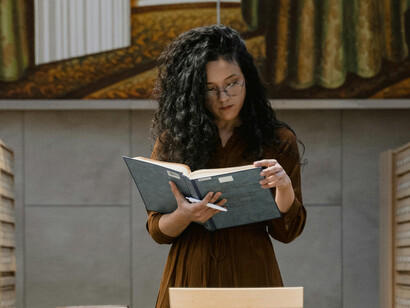Young woman at an archive, investigating