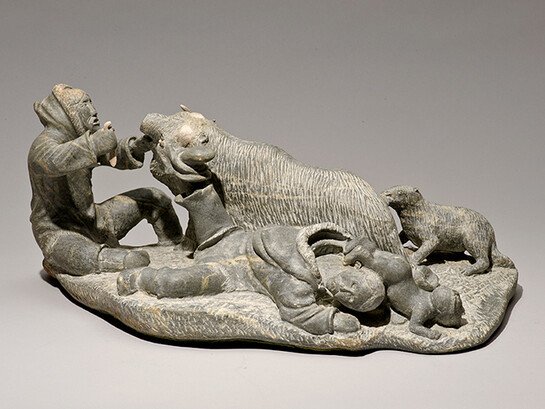Lukie Airut (Igloolik, b. 1942) Woman with Boot Caught on Muskox Horn, 1982. Stone, antler. Collection of the Winnipeg Art Gallery. Gift from the Collection of George and Tannis Richardson, 2011-54Photo: Ernest Mayer, Winnipeg Art Gallery