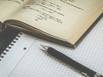 A book and notebook with pen, time to study