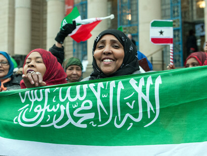 The woman holding the Somaliland flag stands as a testament to the collective aspiration of a people committed to democracy and peace amidst a celebration of their achievements