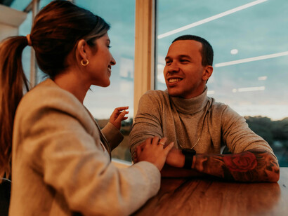 A couple enjoying a deep conversation in a cozy café in Buenos Aires, Argentina, surrounded by the city's warm and inviting atmosphere