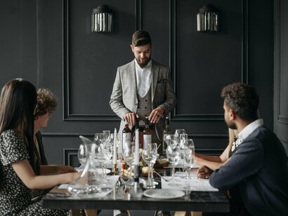 Diners participating in a sophisticated tasting experience, reflecting the growing appeal of aspirational consumption