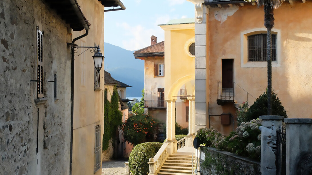 Charming Italian facades and historic properties along narrow lanes in old towns, featuring cozy courtyards, traditional homes, elegant estates, and picturesque views like those around Lake Orta — evoking the romance of Italy’s 1-euro house opportunities