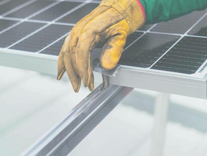 A worker making sure the solar panels, who are a product of linear innovation, are on correctly