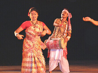 The Bihu dance is a vibrant folk dance from the Indian state of Assam, performed during the Bihu festival to celebrate joy, love, and the spirit of spring. Young men and women dance together with brisk steps, graceful hand movements, and rhythmic swaying that express youthful energy and passion, dressed in colorful traditional Assamese attire