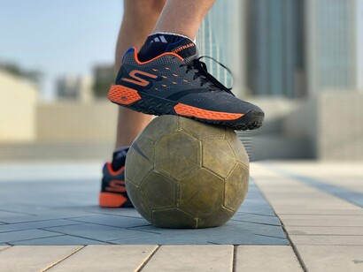 A player confidently resting a foot on a football, representing the first step toward a lifelong World Cup dream