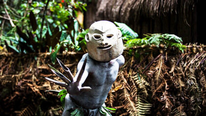 Northeast of the city Mount Hagen, Papua New Guinea, in the rural Paiya Village, an Asaro mudman dons his ancestral clay mask, embodying the fierce spirit of a tribal warrior