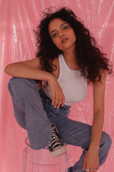 Confidence and style meet in front of the camera, capturing the essence of modern fashion that blends creativity with sustainability