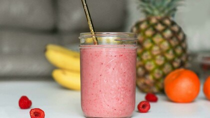 A refreshing smoothie served in a mason jar with a straw