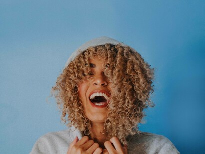 A woman laughing uncontrollably displaying her joy and happiness