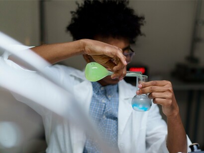 A Black scientist carefully conducting laboratory research, representing the innovation and intellect driving a brighter future