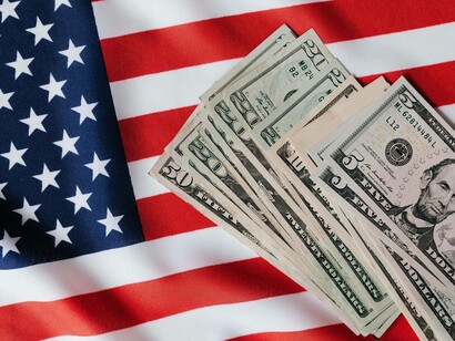 Flagge der Vereinigten Staaten und Stapel von Dollarnoten