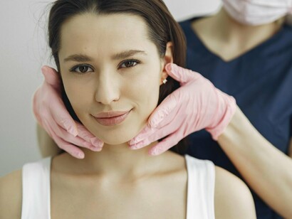 A woman undergoing aesthetic treatment, symbolising the subtle pressure to reshape identity into something more acceptable