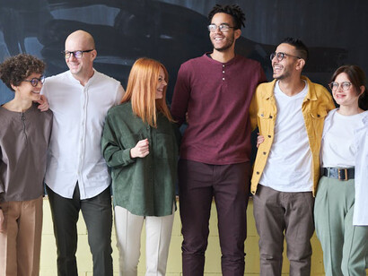 A happy and motivated team environment is created through listening to one another, supporting each other and each other's goals, and cultivating real, human relationships