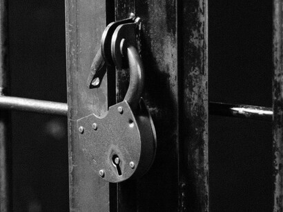 An open lock on a closed door, waiting for the person inside to break free