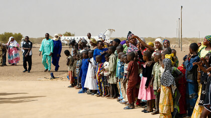 Crowds in Gao, Mali, form a guard of honour for humanitarian workers who arrived by plane in April to assess local needs