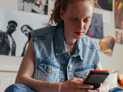 A woman playing Tetris on a handheld video game