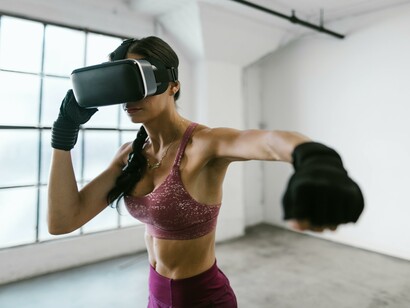 Wellness metaverse: woman practicing boxing with virtual reality gear