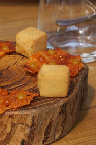 Fried chickpea-flour squares (based on the traditional farinata) and pecorino crackers with dots of purée of smokes paprika