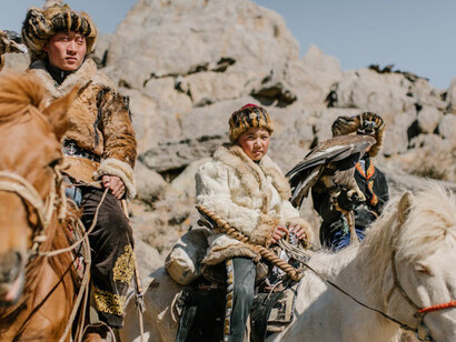 Mongolian nomads in traditional attire riding horses