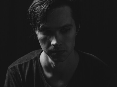 A black-and-white portrait of a man, capturing the feelings of loneliness and isolation associated with incel culture