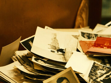 Old photographs displayed inside a vintage suitcase