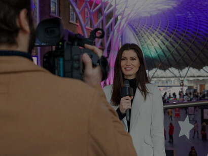 A close-up of a man holding a camera