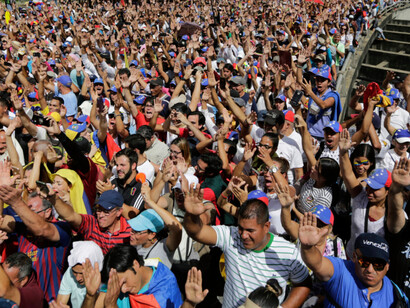 Thousands of Venezuelan citizens march in protest of their political crisis in search of freedom from the current regime