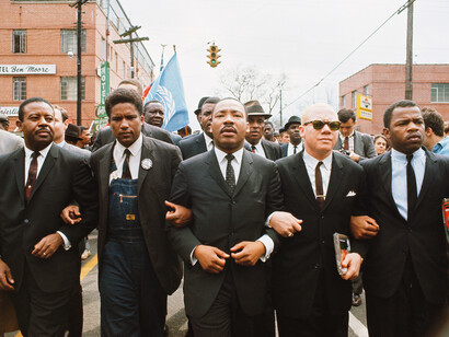 Steve Schapiro, Martin Luther King Jr. Marching for Voting Rights with John Lewis, Reverend Jesse Douglas, James Forman, and Ralph Abernathy, Selma (color) (detail), 1965. Courtesy of Fahey/Klein Gallery
