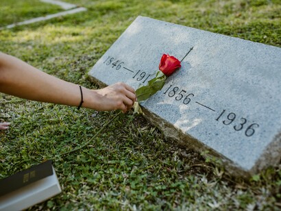 Pessoa deixa flor em lápide. Tudo aqui é frequência, vibração, tudo aqui está sob regência das leis da criação e destruição. Do ir e vir. Em cada ciclo de nossas vidas e mortes, são muitos assuntos a tratar para curar. Percebo em mim. Percebe em você? Aí estará o mecanismo da consciência, outro tema a se explorar a parte, mas que a esse respeito, é capaz de passar de um nível para outro da existência, consciente entre vida morte vida na vida, vida na morte
