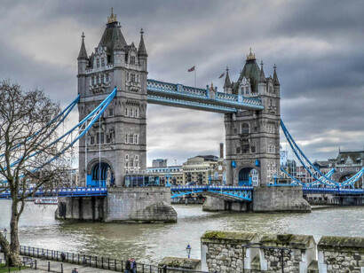 A stunning view of London’s Tower Bridge silhouetted against a brooding, cloudy sky
