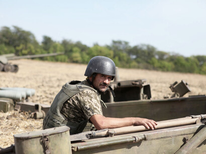 A middle-aged soldier handling artillery