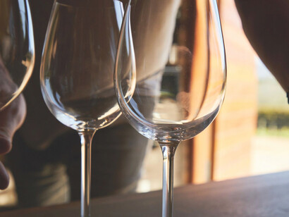 A man pours the rich, velvety wine into the awaiting bottles with a practiced hand, orchestrating a graceful and meticulous ritual